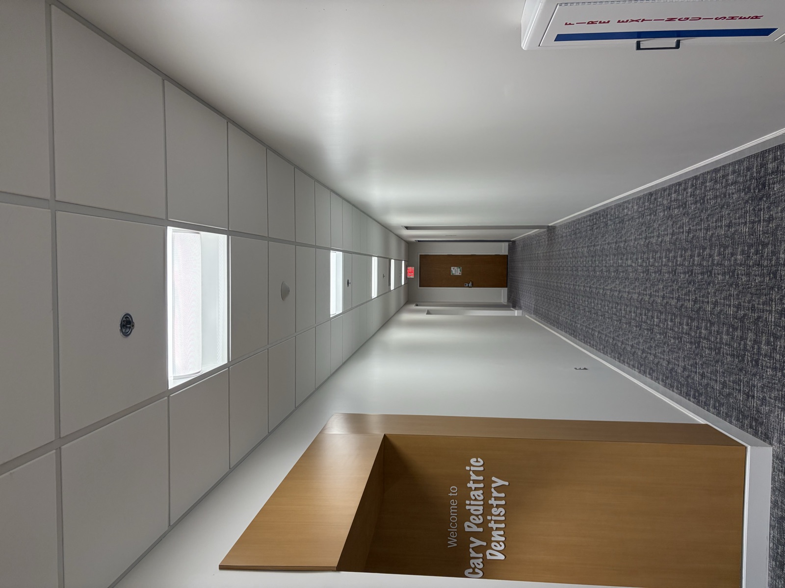 Empty medical office corridor before interior wayfinding signage installation